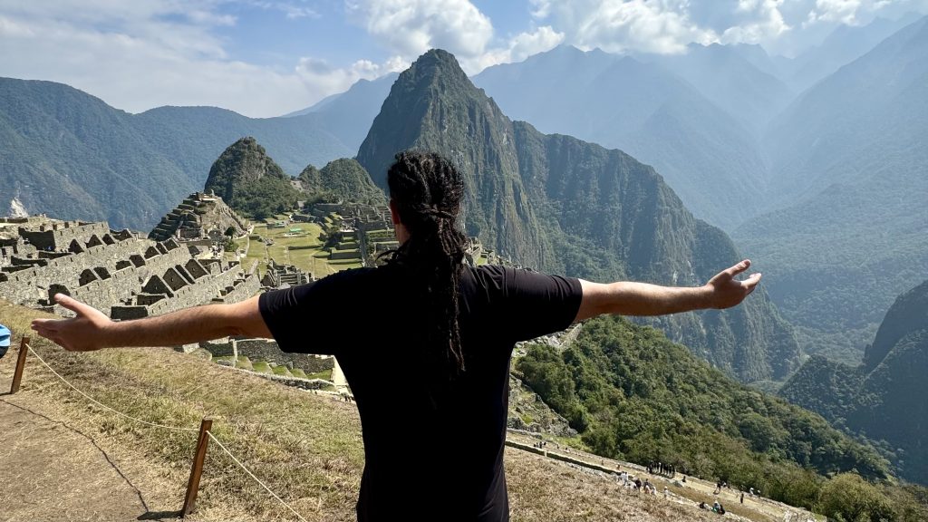 Anyextee stands before Machu Picchu 