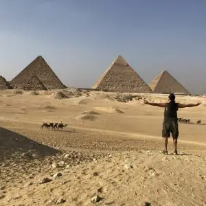 anyextee stands facing giza pyramids